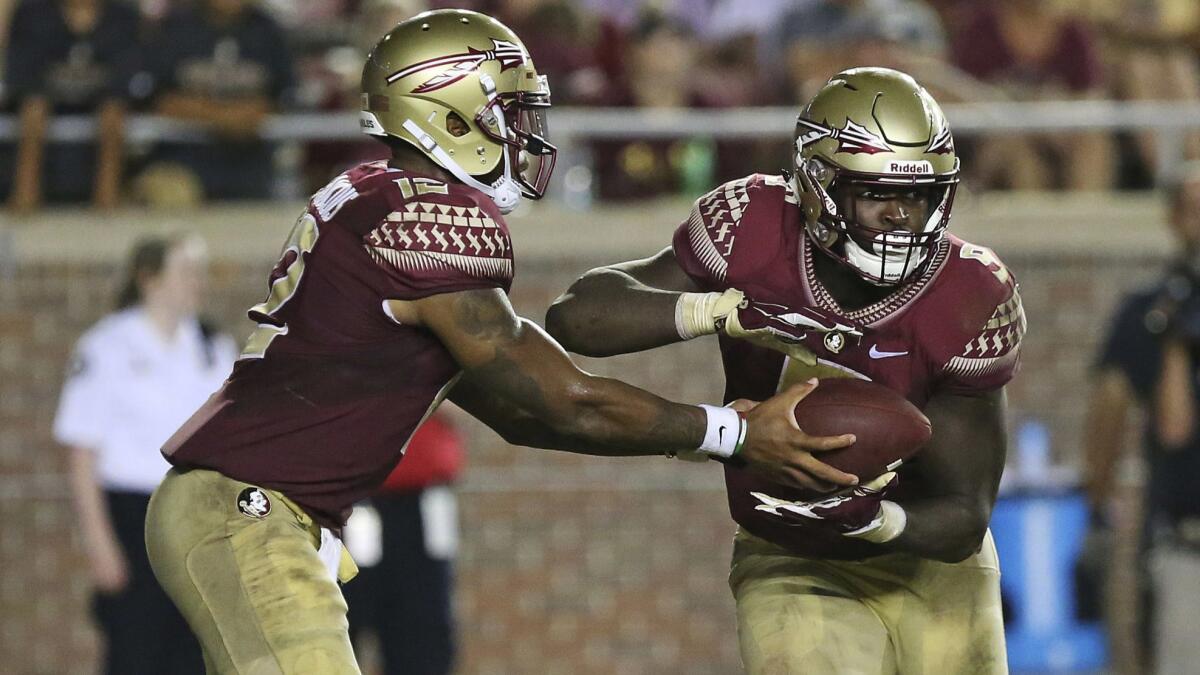 Florida State's Deondre Francois hands the ball to running back Jacques Patrick as they try to get out of bad field position against Samford in the third quarter on Sept. 8 in Tallahassee, Fla. Florida State won 36-26.