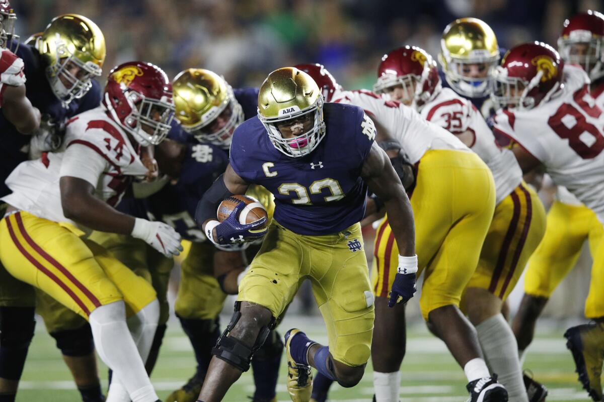 Notre Dame running back Josh Adams breaks into the clear on a 14-yard touchdown run in the fourth quarter against USC last season in South Bend, Ind. The Trojans and Irish will meet for the 90th time this Saturday at the Coliseum.