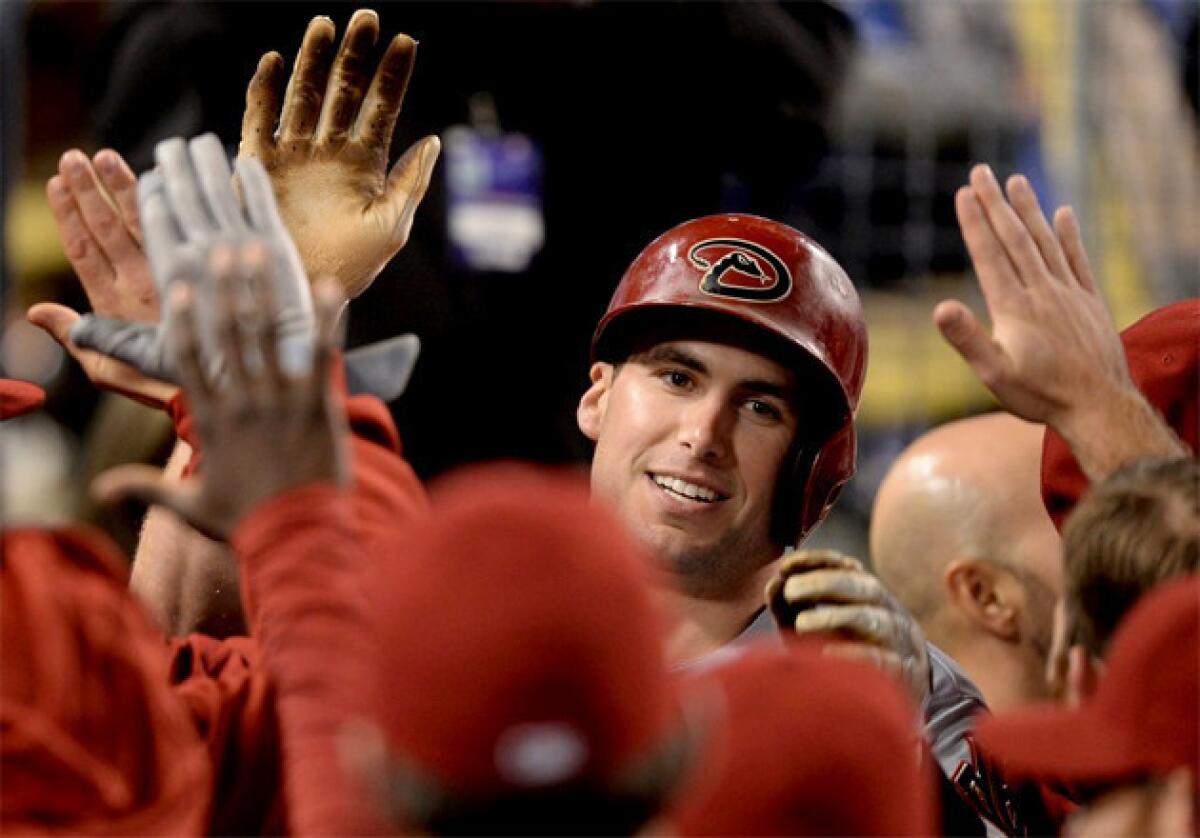 Arizona Diamondbacks' Paul Goldschmidt celebrates his go-ahead two-run home run in the dugout.