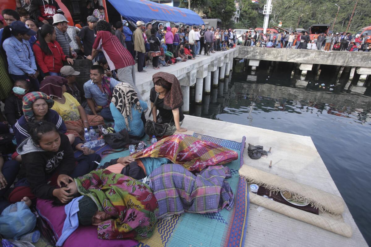 Relatives of victims of a sunken ferry wait for news at the Tigaras port at Lake Toba, North Sumatra, on Wednesday.