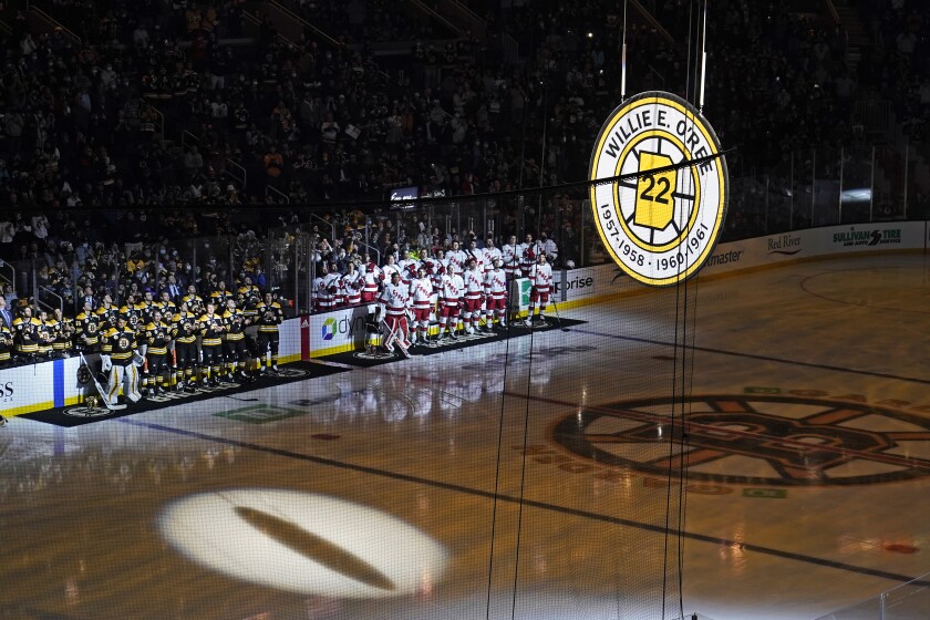 The #22 of Boston Bruin Willie O'Ree is hoisted to the rafters of the TD Boston Garden during a ceremony prior to an NHL hockey game, Tuesday, Jan. 18, 2022, in Boston. O'Ree, the NHL's first Black player, attended the ceremony remotely via video. (AP Photo/Charles Krupa)