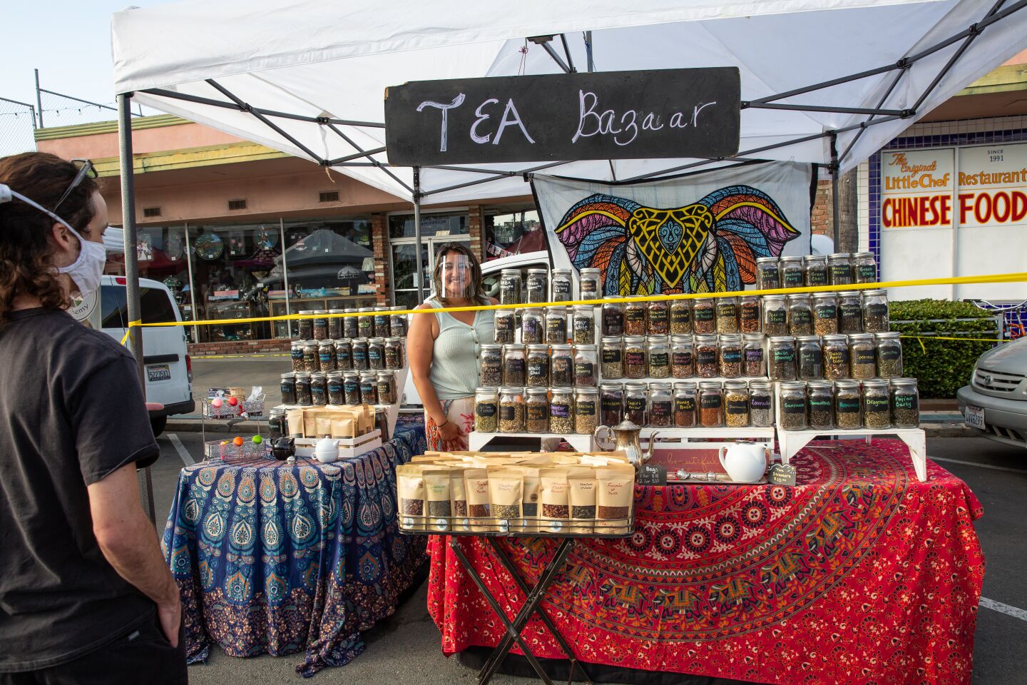 Shell Singal, owner of Tea Bazaar, sets up shop at the Ocean Beach Farmers Market.