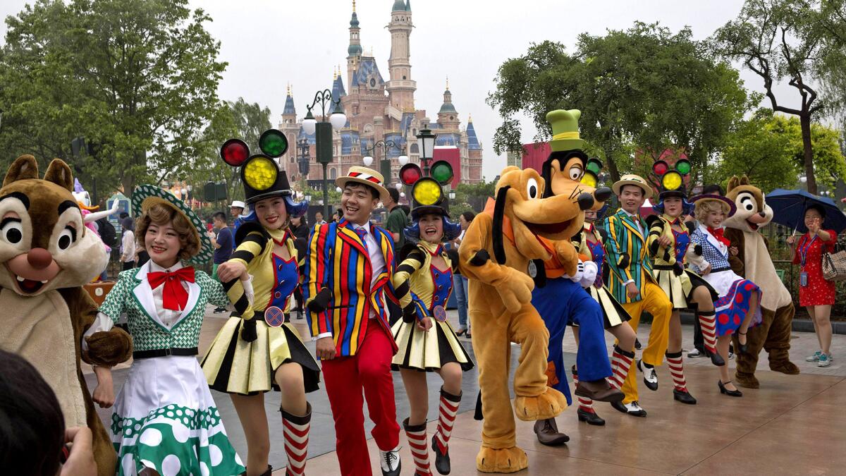 Performers take part in a parade at the Disney Resort in Shanghai on the eve of its grand opening.