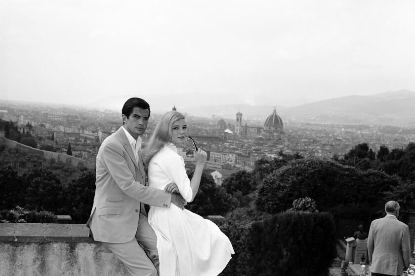 American actor George Hamilton and French actress Yvette Mimieux spend a break in the shooting of a new film, "Luce sulla Piazza" (Light in the Square), enjoying the beautiful view over great part of Florence from the Belvedere Fort, May 29, 1961. (AP Photo/Giulio Torrini)