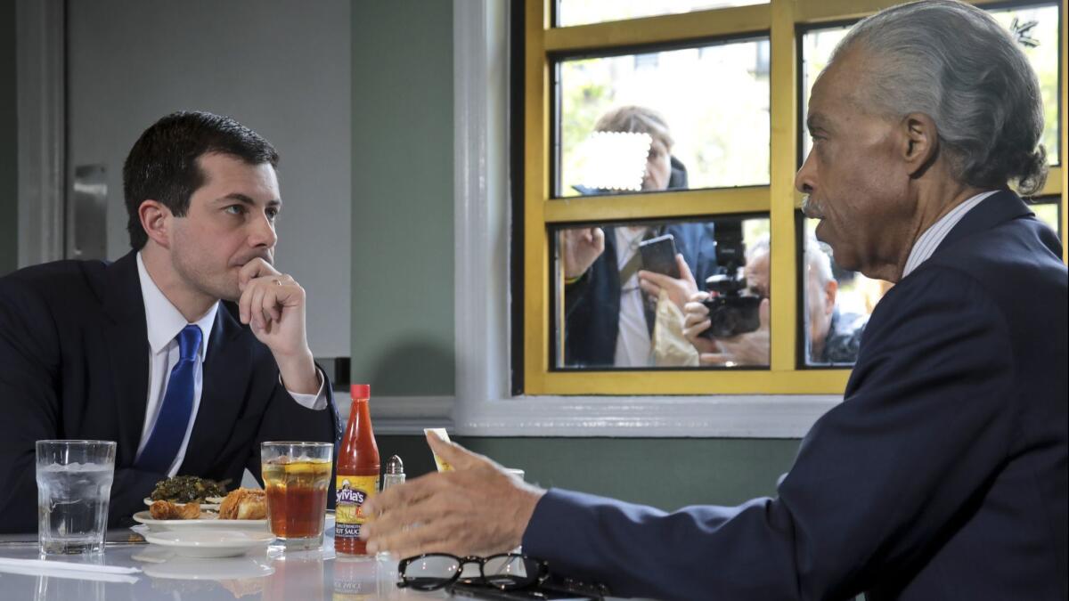 Democratic presidential candidate Pete Buttigieg and civil rights leader Al Sharpton at Sylvia's Restaurant in Harlem, N.Y.