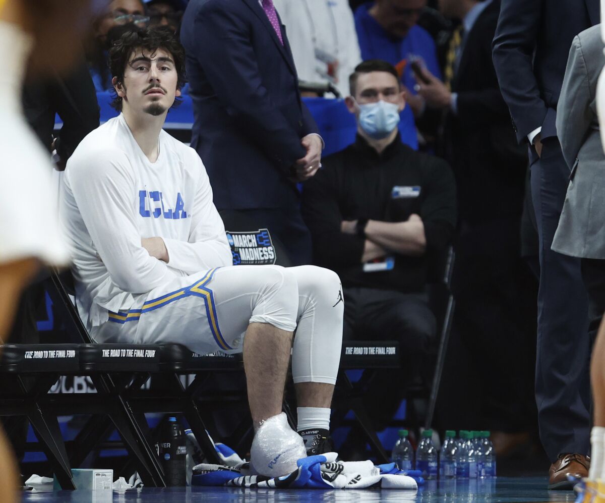 UCLA's Jaime Jaquez Jr. sits on the bench with ice on his ankle after suffering a second-half injury Saturday. 