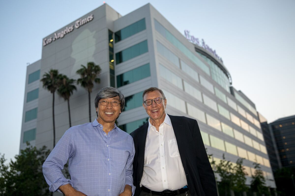 Dr. Patrick Soon-Shiong and Norman Pearlstine stand outside the L.A. Times building in El Segundo in July 2018. 