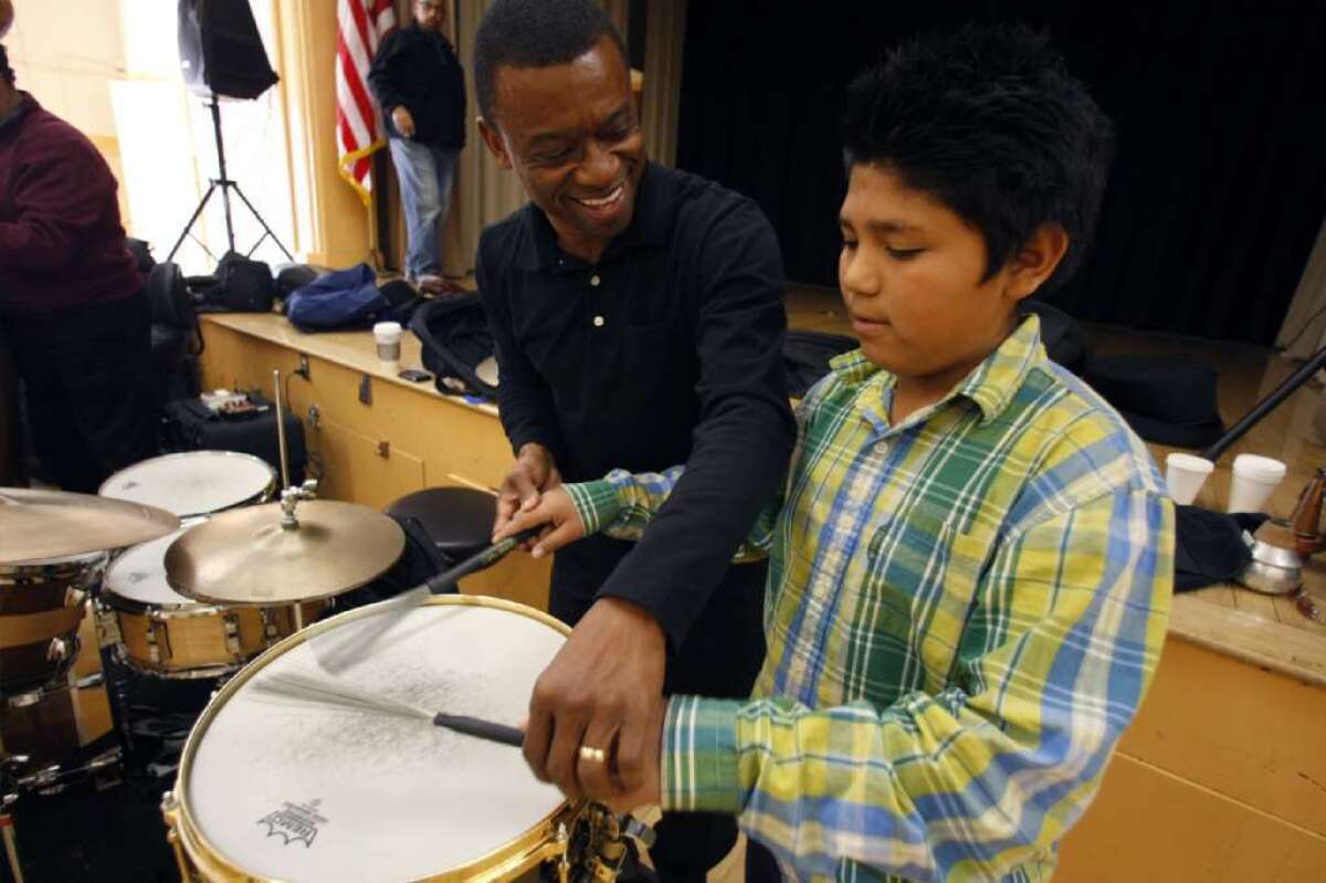 Jazz drummer Clayton Cameron gives a lesson to LAUSD student Tomas Ramos in this 2011 photo. A bill signed into law Monday will allow California taxpayers to donate to arts education via a checkoff on state income tax forms.