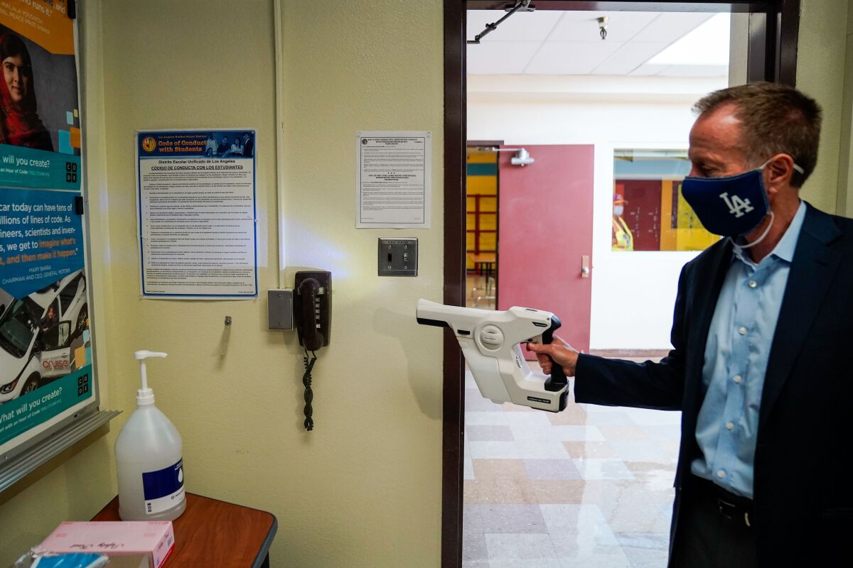 LAUSD Supt. Austin Beutner demonstrates the use of sanitizing tools while taking a tour of Burbank Middle School.