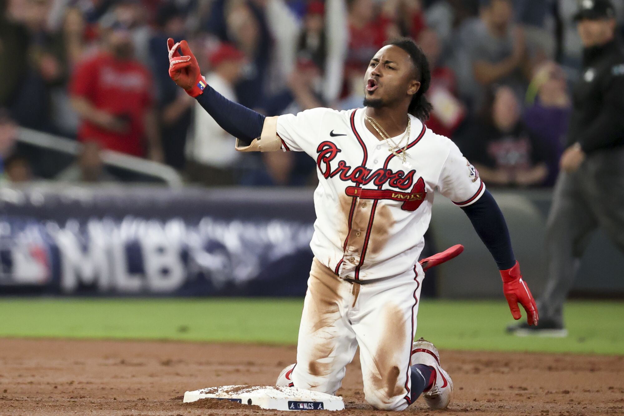 Atlanta Braves' Ozzie Albies reacts after a double during the first inning.
