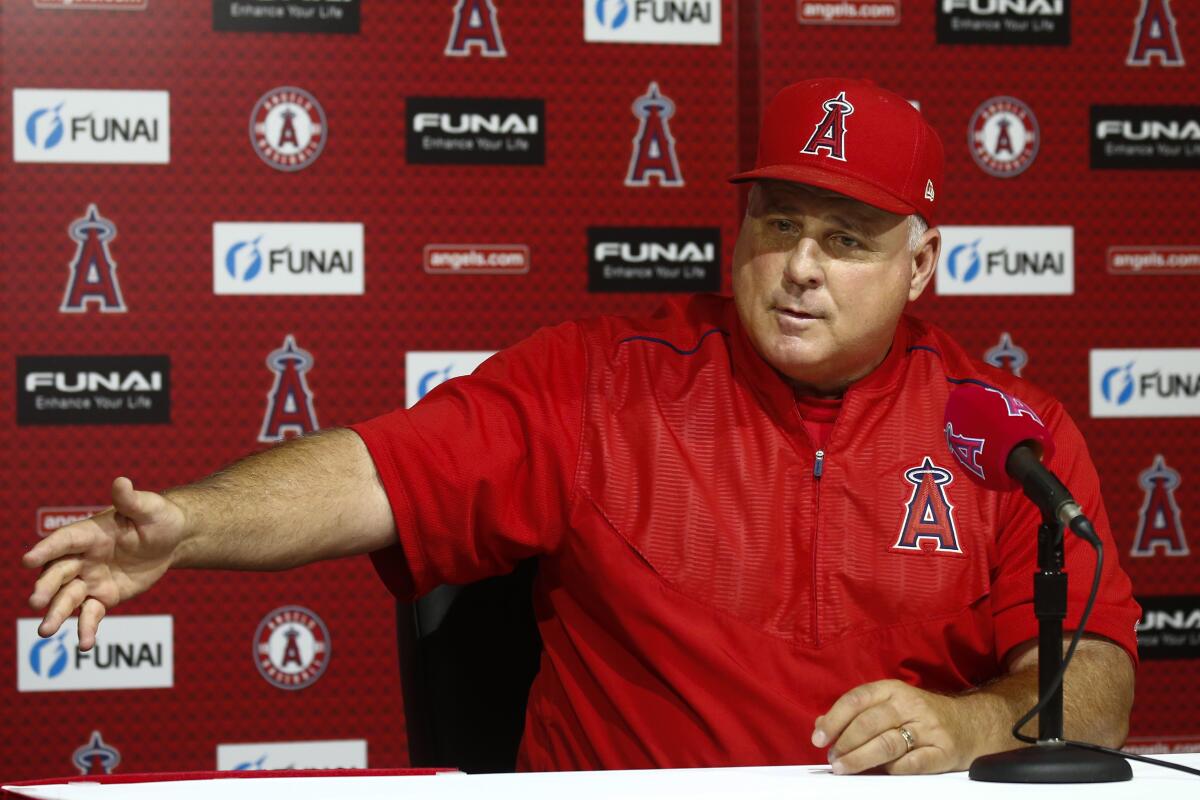 Mike Scioscia speaks at an Angels news conference.