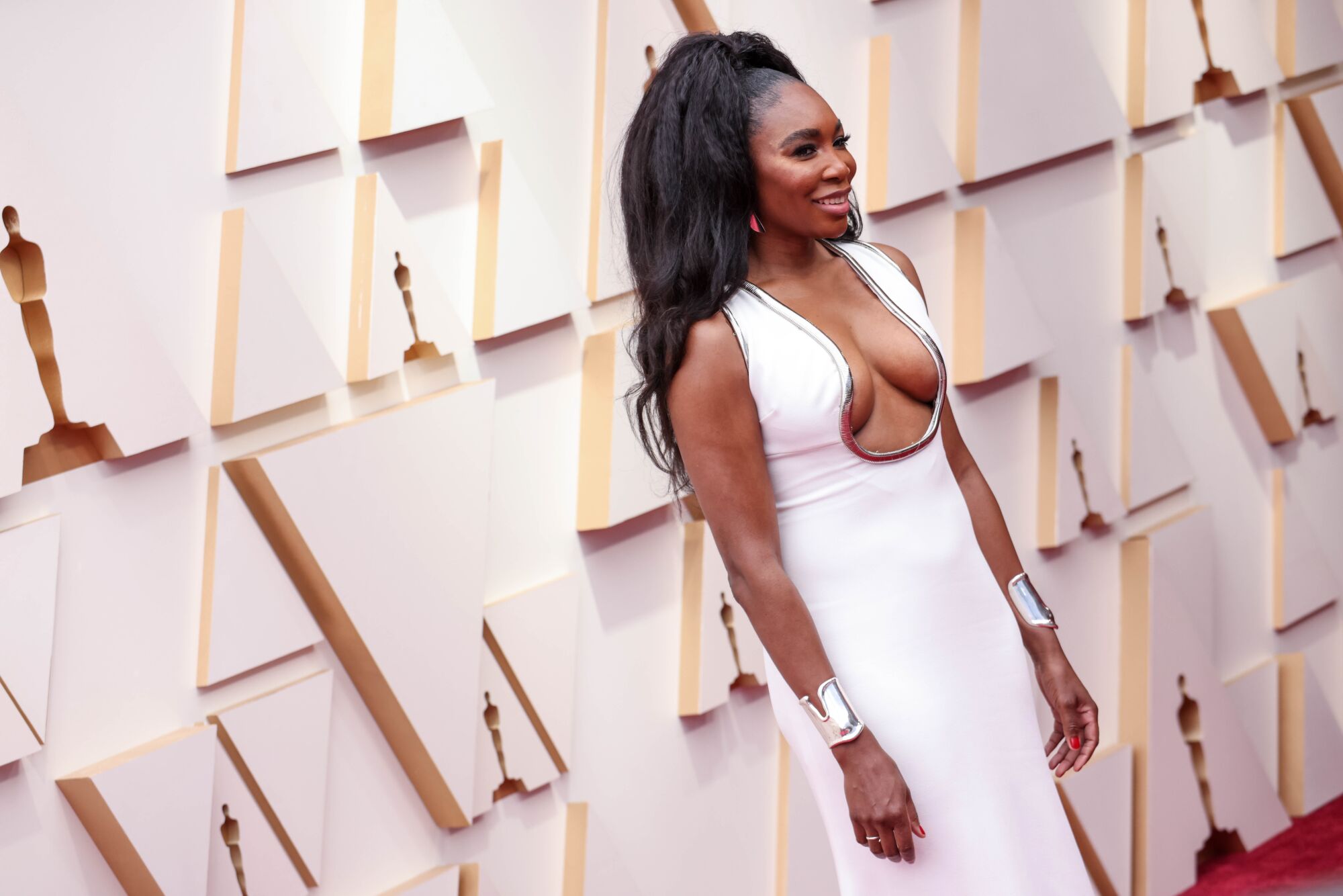 A woman in a white gown on the red carpet