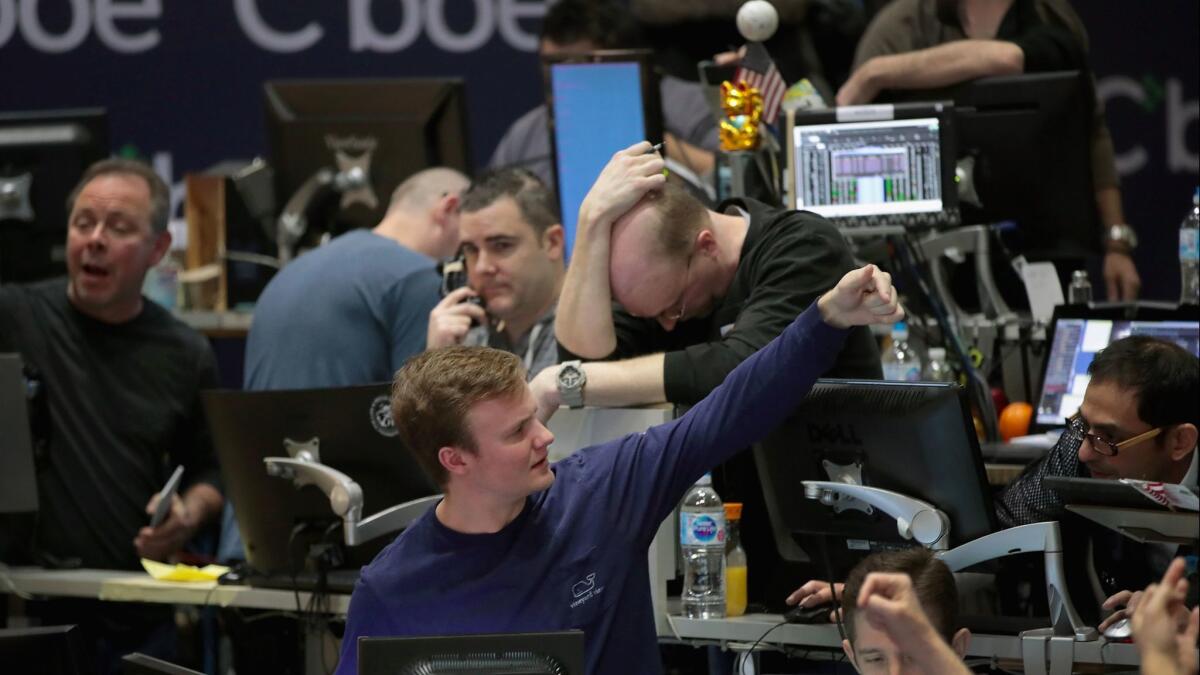 Traders signal offers at the Cboe Global Markets Inc. exchange on Feb. 6, 2018, in Chicago.