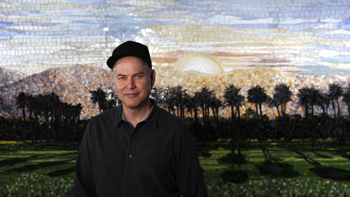 Concert promoter Paul Tollett, the longtime president of Goldenvoice Productions, is photographed in front of a mosaic of the Coachella landscape, at his headquarters in DTLA. Tollett cofounded the Coachella Valley Music and Arts Festival in Indio, now heading into its 20th year.