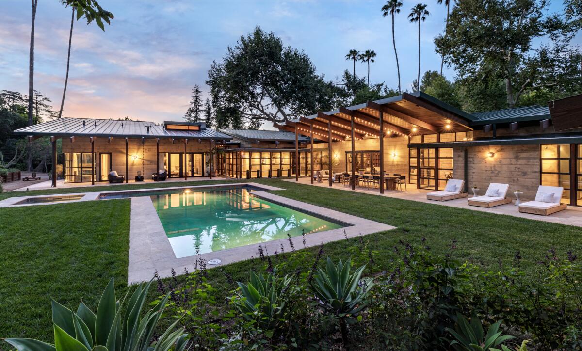 The three-acre estate centers on a series of wood-and-glass pavilions that wrap around a central courtyard.
