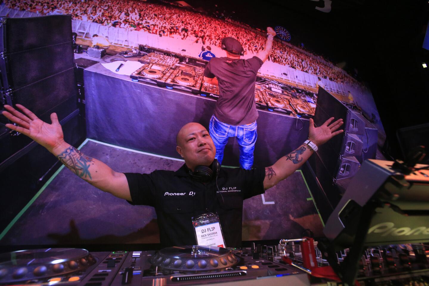 DJ Flip (aka Rick Sajorda) rocks the Pioneer booth at the NAMM Show at the Anaheim Convention Center last month.