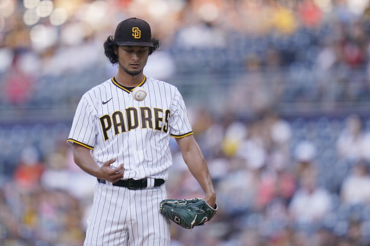 San Diego Padres starting pitcher Yu Darvish pauses during the first inning of the team's baseball game against the Los Angeles Dodgers on Wednesday, Sept. 8, 2021, in San Diego. (AP Photo/Gregory Bull)