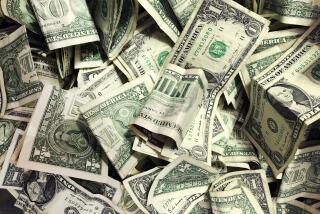 Dollar bills have been dropped into a tip jar at a carwash in the Brooklyn borough of New York, Jan. 21, 2020. (AP Photo/Mark Lennihan)