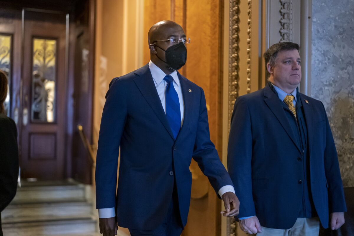 FILE— Sen. Raphael Warnock, D-Ga., leaves the Senate chamber at the Capitol in Washington on April 7, 2022. Warnock’s reelection campaign announced on Thursday, April 14, 2022 that it raised $13.6 million in the first three months of 2022, what the campaign says is the most money ever raised by a U.S. Senate candidate in the first quarter of an election year. (AP Photo/J. Scott Applewhite)