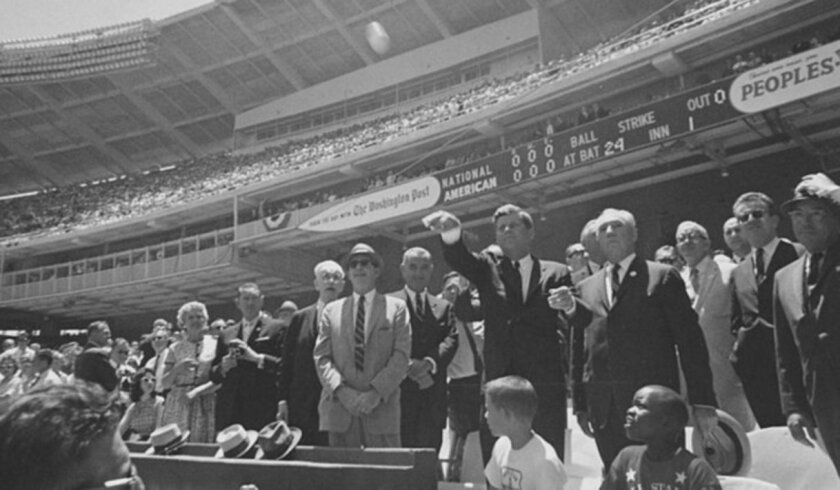 President John F. Kennedy throws out the first pitch before the 1962 All-Star Game played in Washington, D.C.