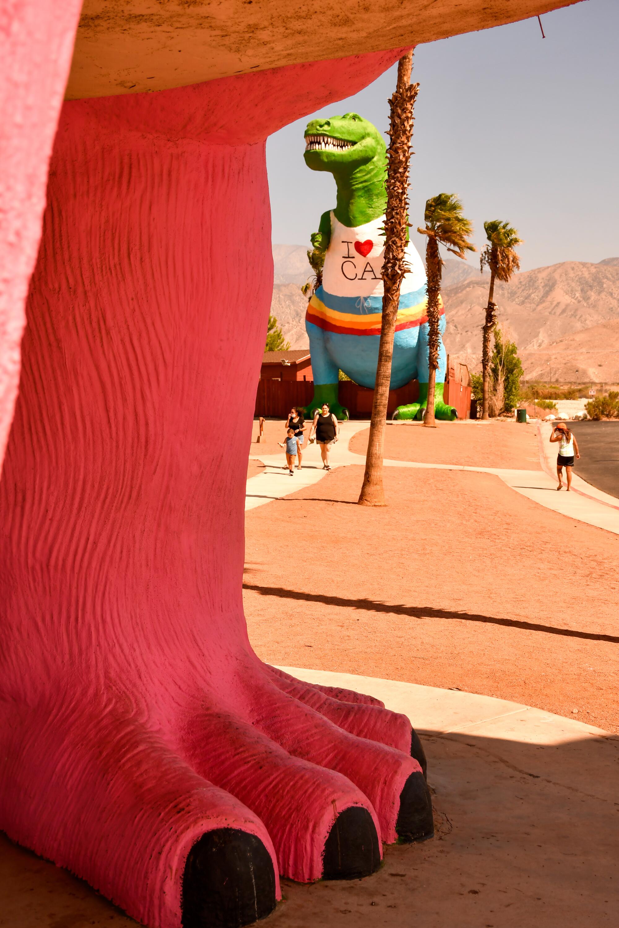 A giant dinosaur with a shirt saying "I heart CA" 