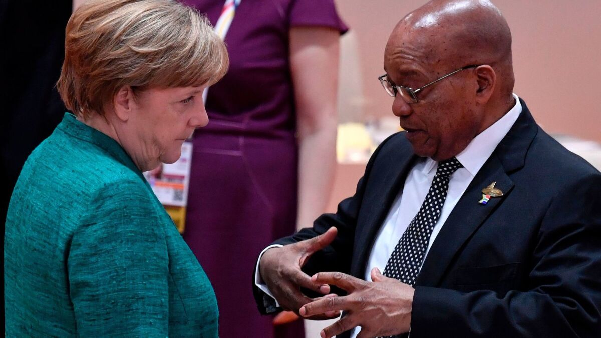 German Chancellor Angela Merkel talks with South African President Jacob Zuma at the Group of 20 Summit in Hamburg, Germany, on Saturday.