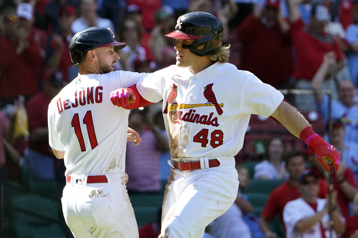 St. Louis Cardinals' Harrison Bader (48) is congratulated by teammate Paul DeJong (11) after hitting a two-run home run during the seventh inning of a baseball game against the Arizona Diamondbacks Sunday, May 1, 2022, in St. Louis. (AP Photo/Jeff Roberson)