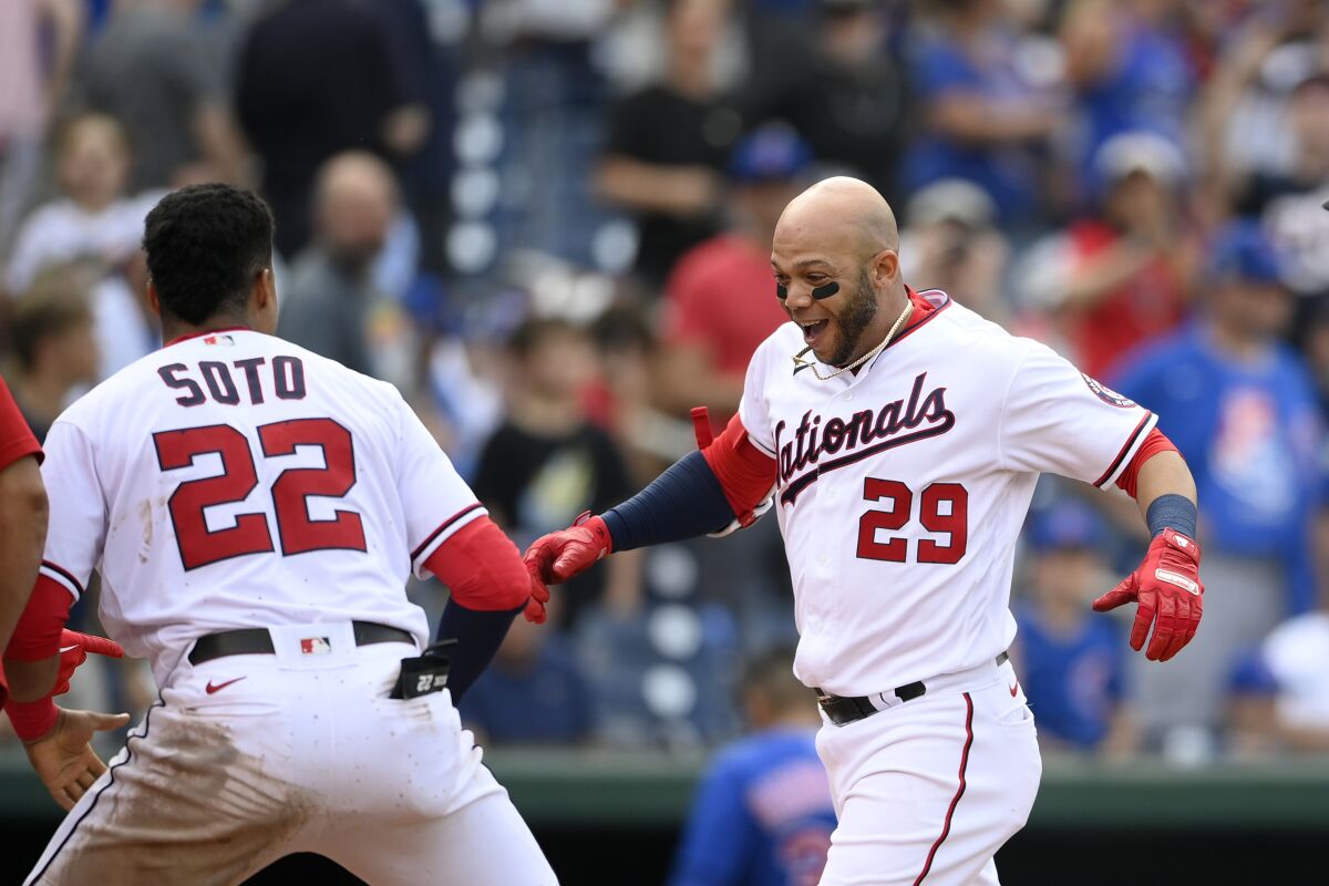 Washington Nationals' Yadiel Hernandez (29) celebrates his walkoff home run with teammate Juan Soto (22) as he heads toward home during the ninth inning of a baseball game against the Chicago Cubs, Sunday, Aug. 1, 2021, in Washington. (AP Photo/Nick Wass)