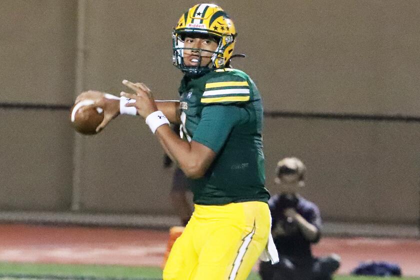 Edison's quarterback Save Niumata (11) looks for an open receiver