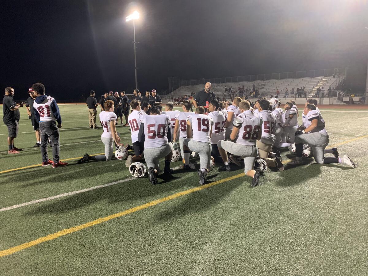 Coach Luis Nuñez praises his Ocean View team after it rallied to a 40-26 nonleague victory at University in Irvine on Friday.