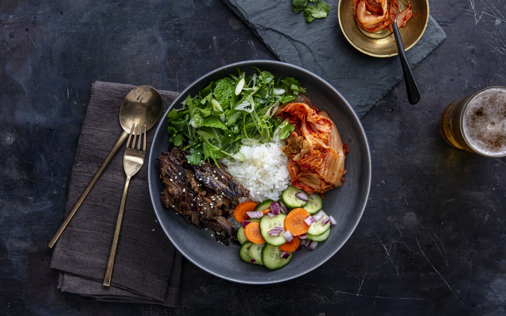 Beef bulgogi bowl with kimchi and fresh pickles.