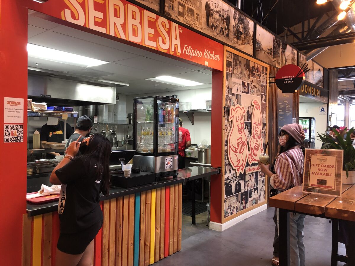 Diners queue up at Serbesa Filipin Kitchen at the Market on 8th food hall in National City.