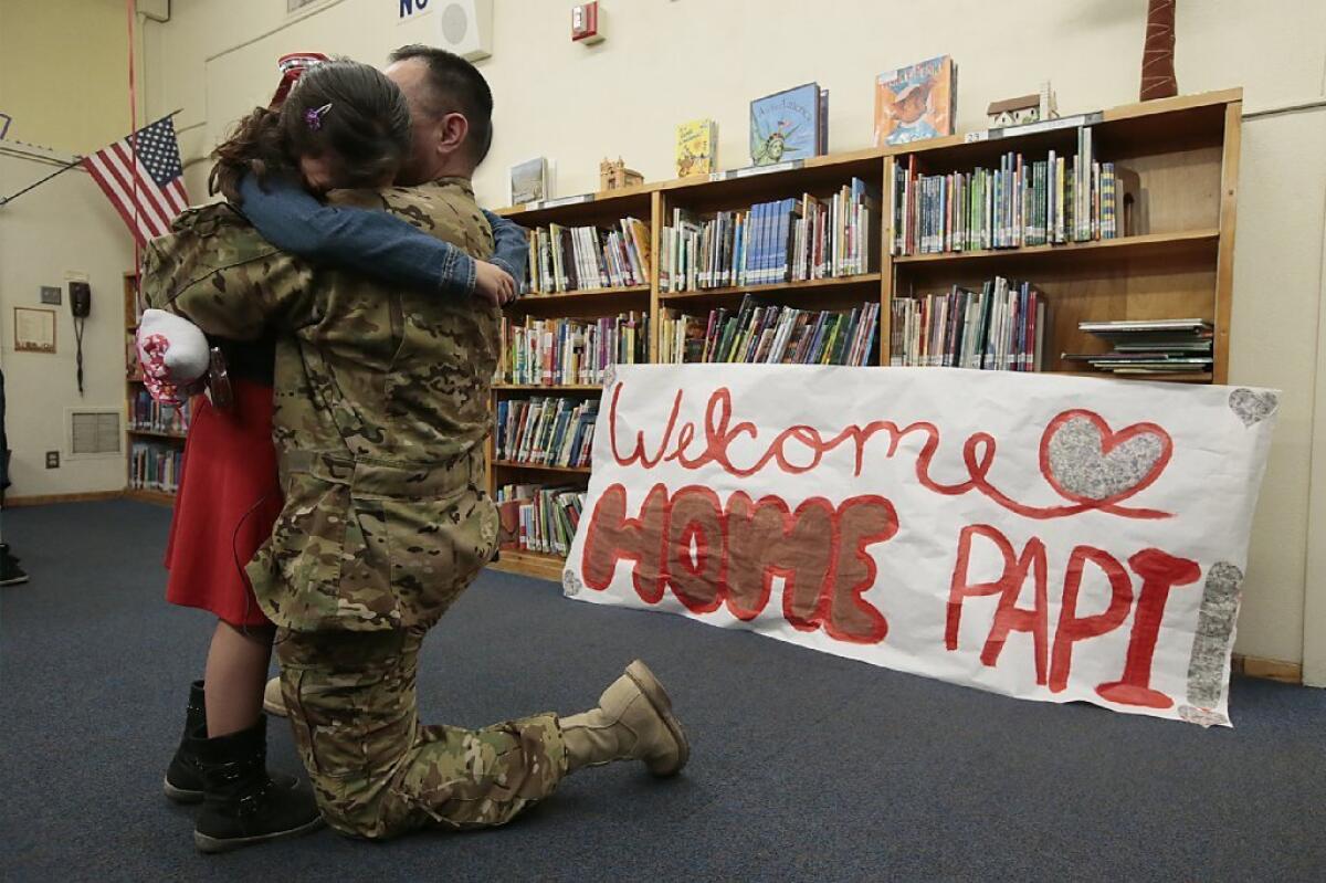 A member of the U.S. California Army National Guard reunites with his daughter after being deployed for nearly a year. A new study finds that California children with a parent in the military were more likely than their peers to attempt suicide.