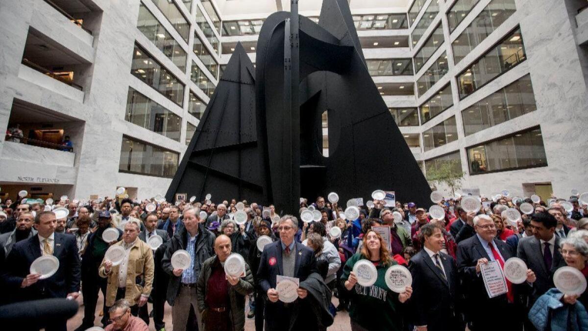 Furloughed government workers affected by the shutdown hold a silent protest on Capitol Hill on Jan. 23.