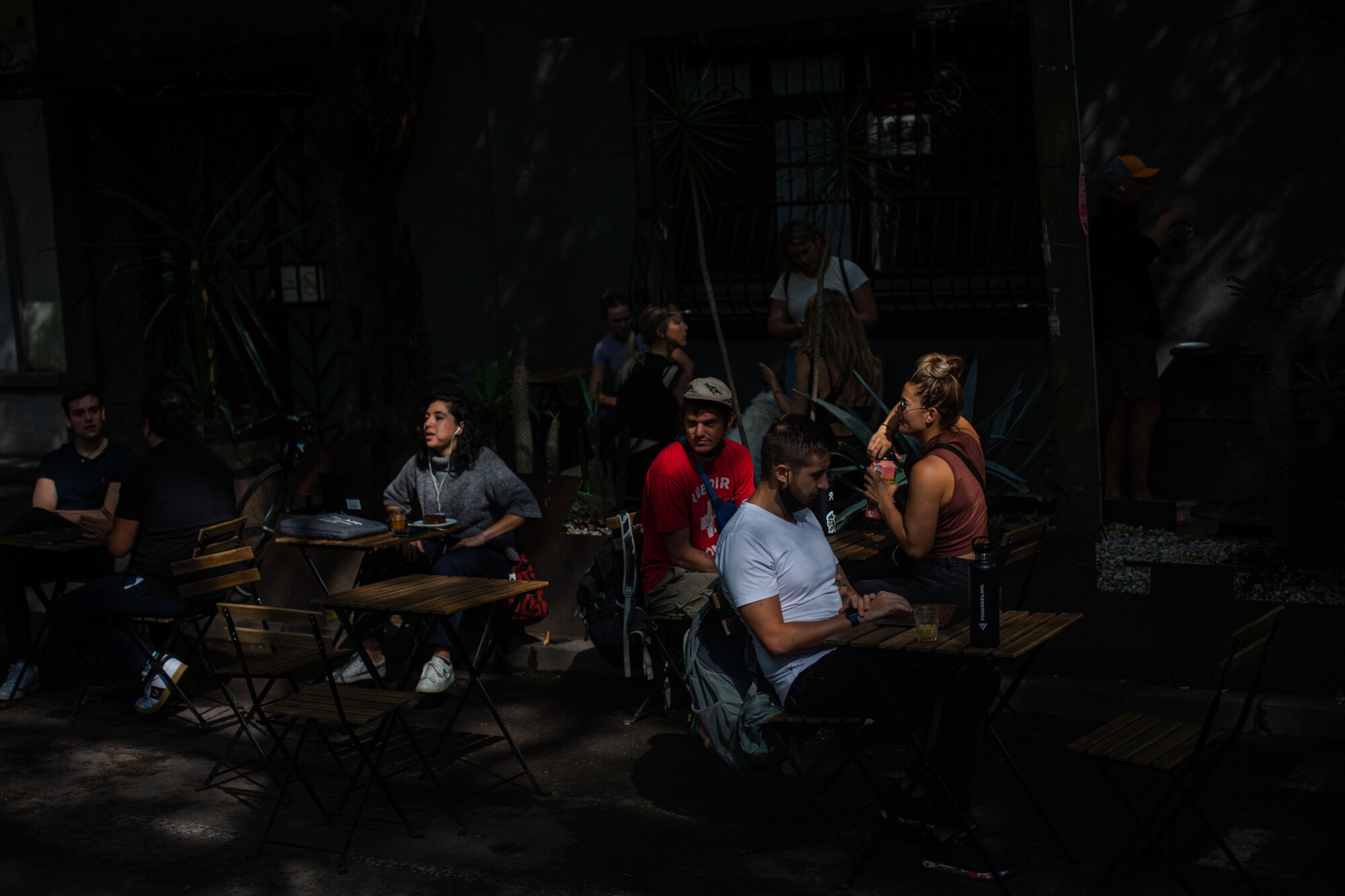 afe-goers sit at Quentin Cafe, a coffee shop popular with Americans and remote-workers 