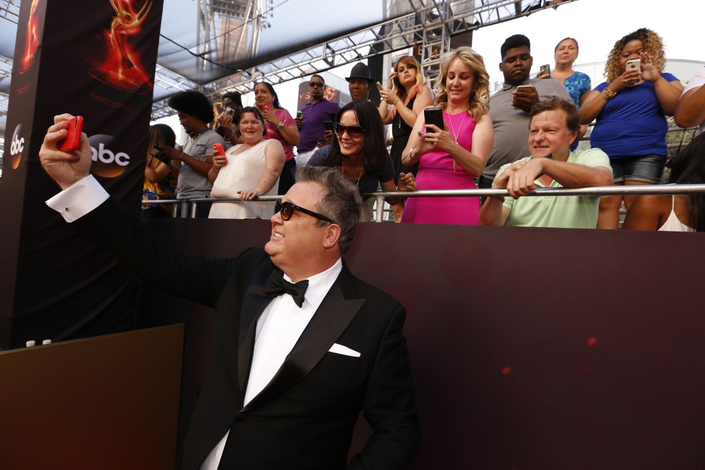 Eric Stonestreet takes a selfie with fans.