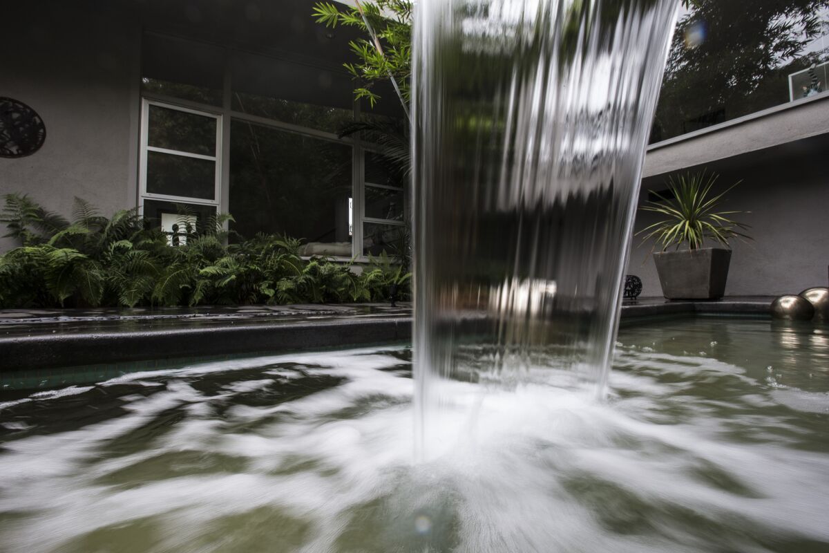 Water flows into a small pool in the back courtyard of a home in Beverly Hills. The city is Southland's biggest water user, officials announced Tuesday.