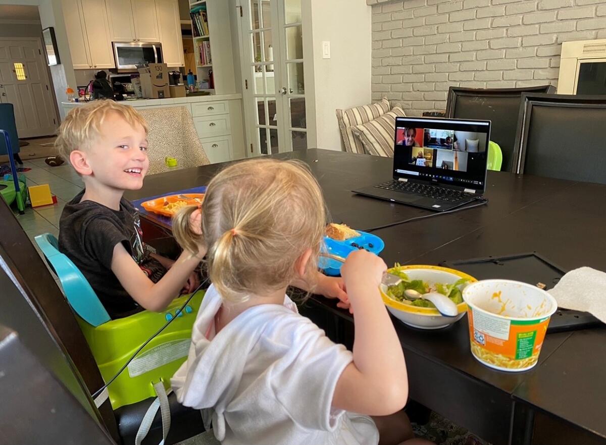 Five-year-old Cadman Coller participated in a distance learning lesson next to Emma, his 3-year-old sister, last spring.  