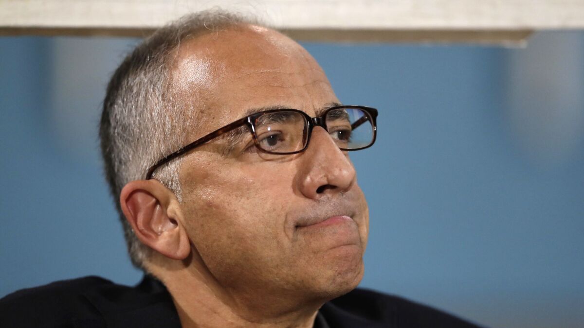 Carlos Cordeiro, vice president of U.S. soccer, watches warmups from the team bench ahead of the start of the U.S. men's World Cup qualifying match against Trinidad and Tobago.