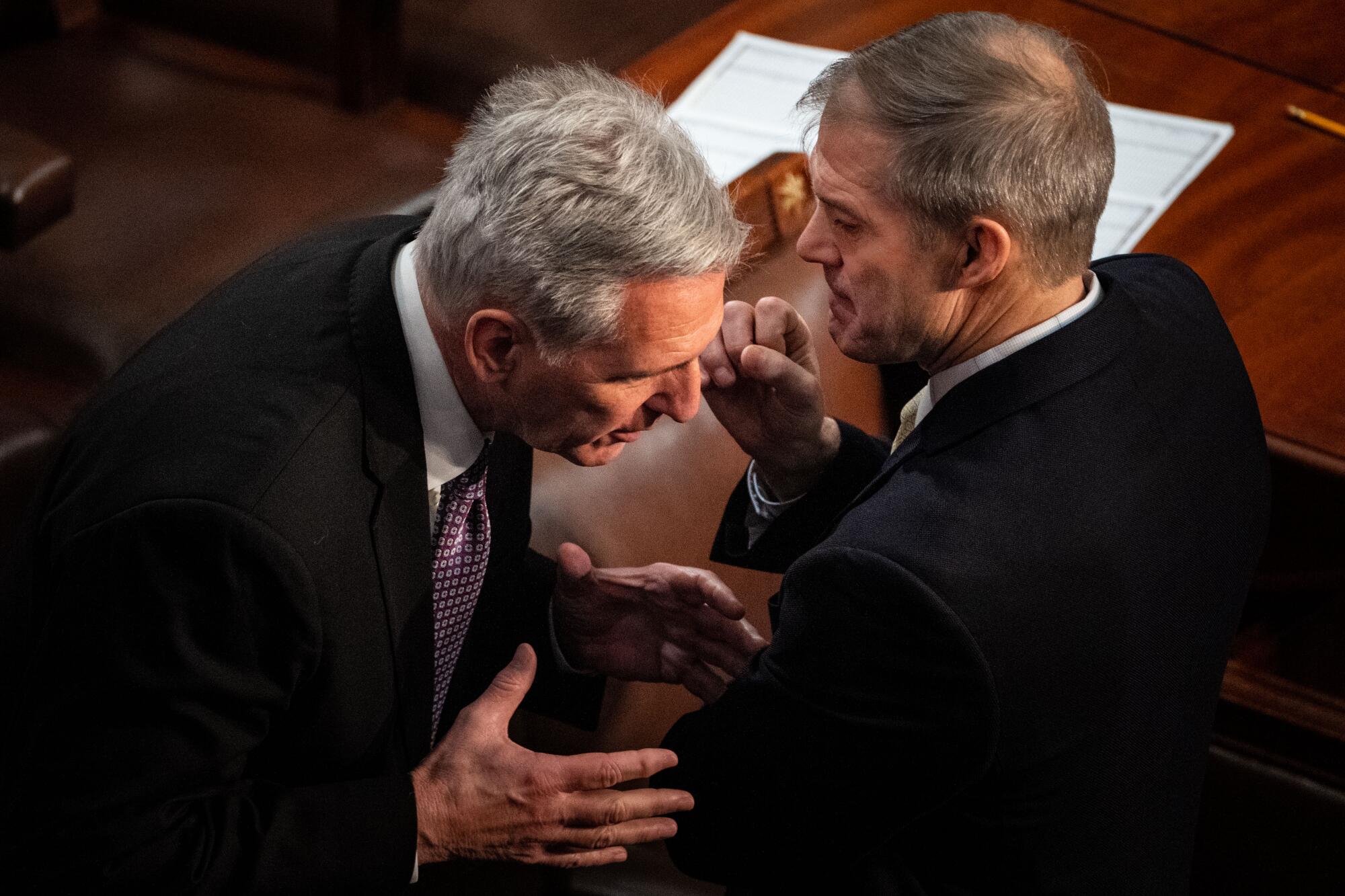 Kevin McCarthy confers with Jim Jordan on the House floor