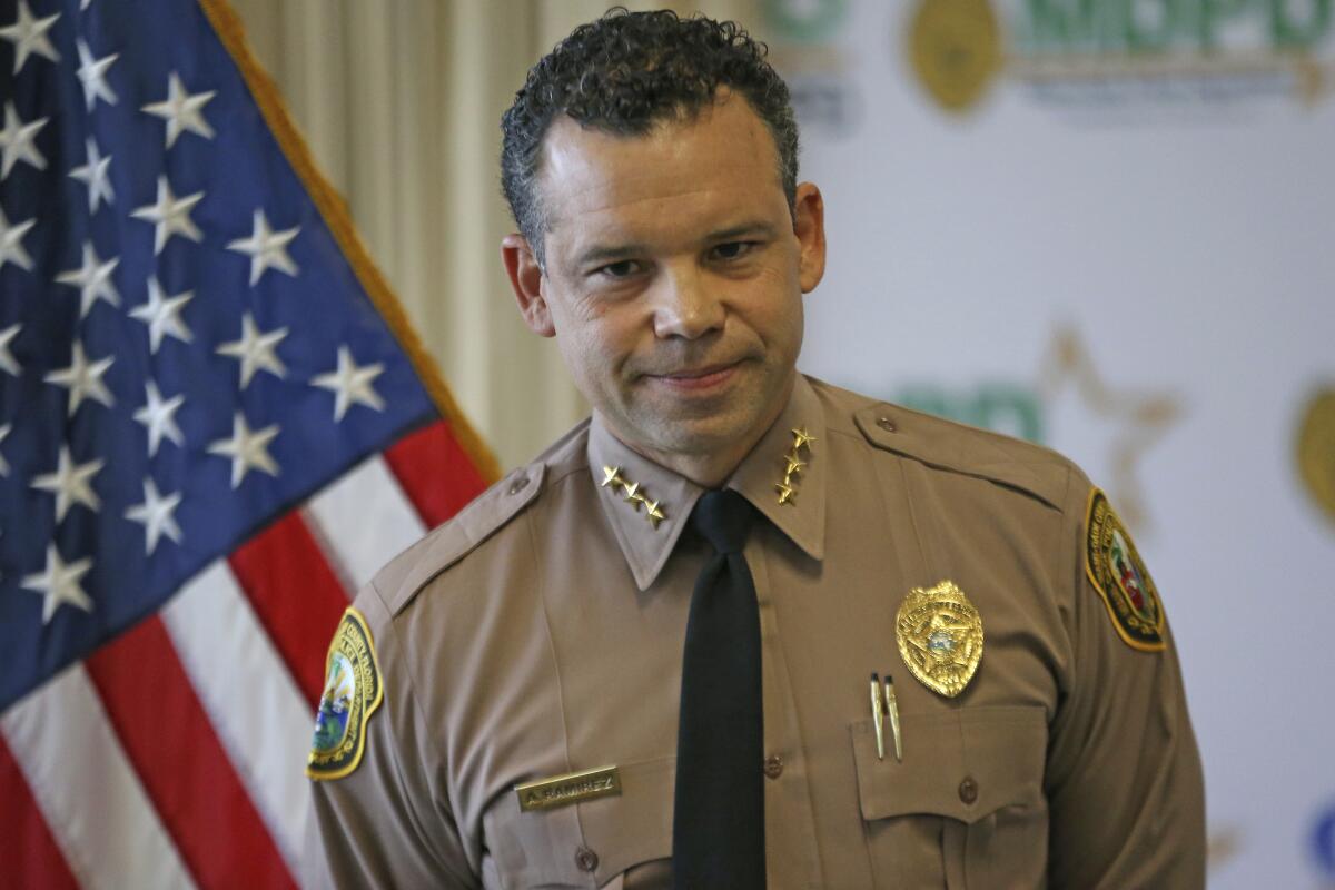 Alfredo "Freddy" Ramirez wears a police uniform during a news conference.