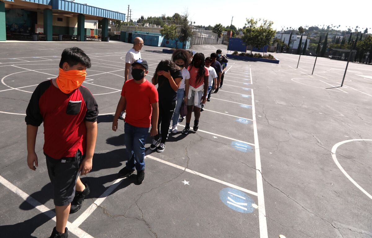 Children line up on a school playground