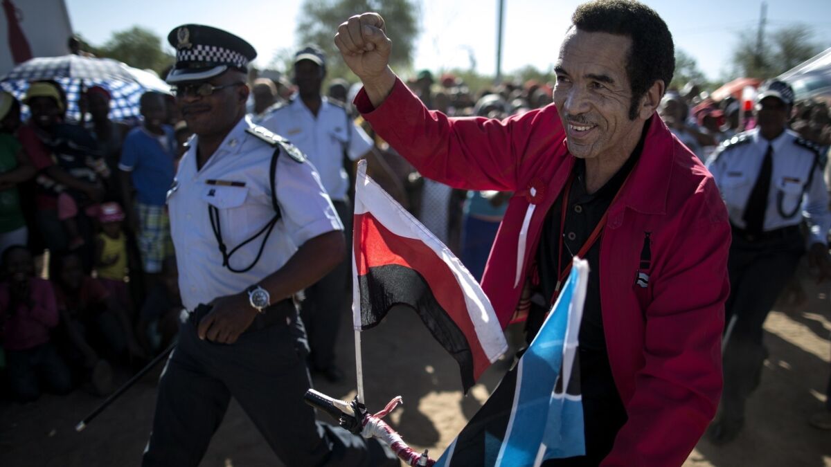 Ian Khama rides a bicycle while campaigning as incumbent for the Botswana presidency in October 2014. On Saturday, he retired after a decade in the post.