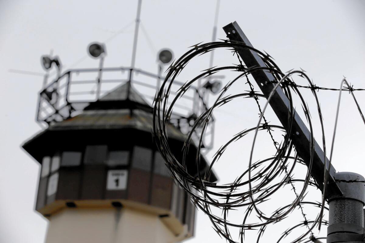 The iconic guard tower No. 1 at San Quentin State Prison is framed by the razor wire atop the perimeter fences.