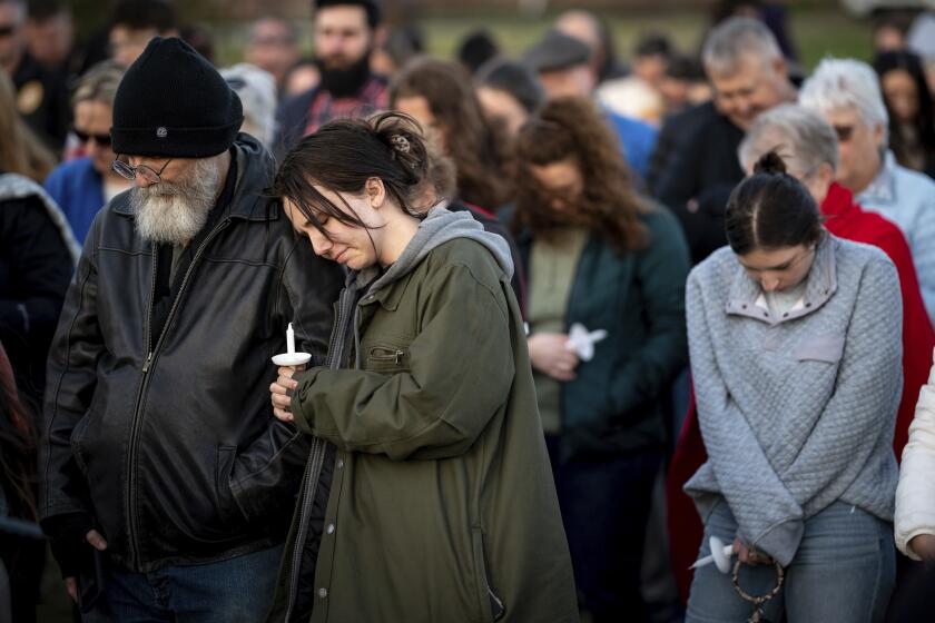 People pray during a community vigil held for the people killed during the Covenant School shooting on Tuesday, March 28, 2023, in Mt. Juliet, Tenn. (Andrew Nelles/The Tennessean via AP)