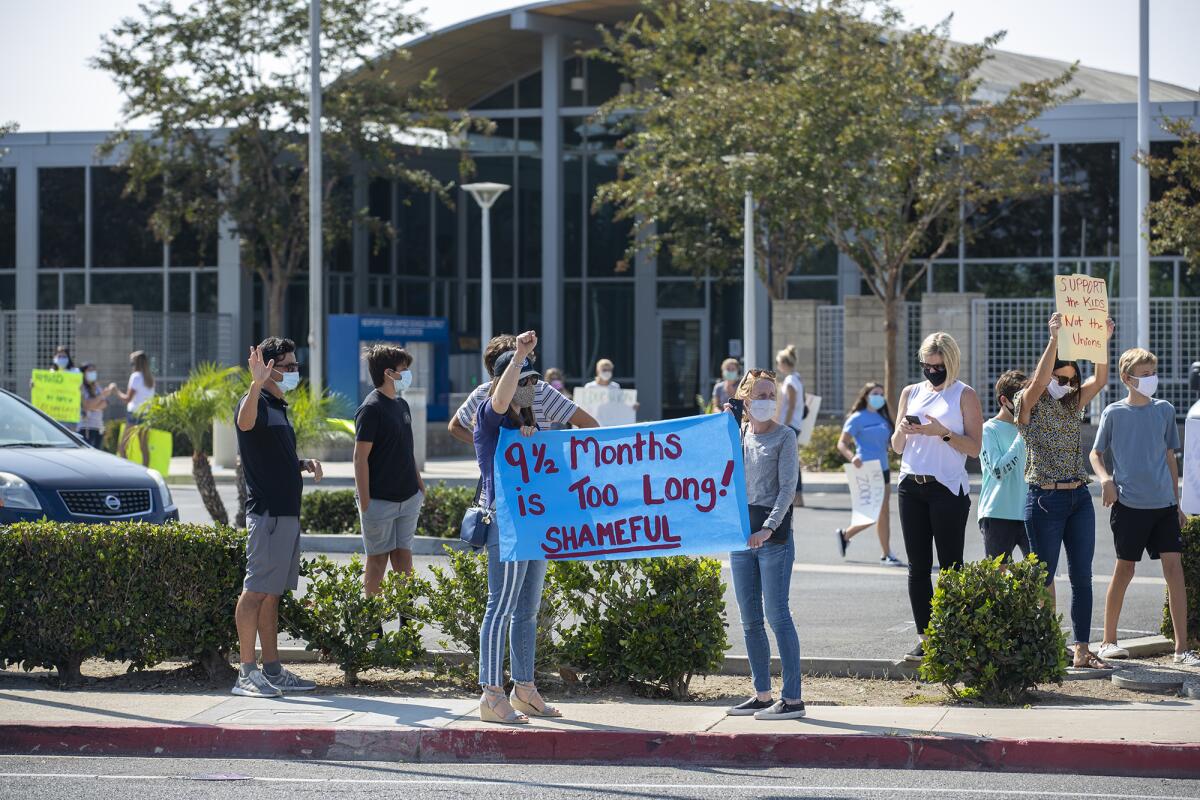 Students and parents protest outside of the Newport-Mesa Unified School District offices in Costa Mesa on  October 8.