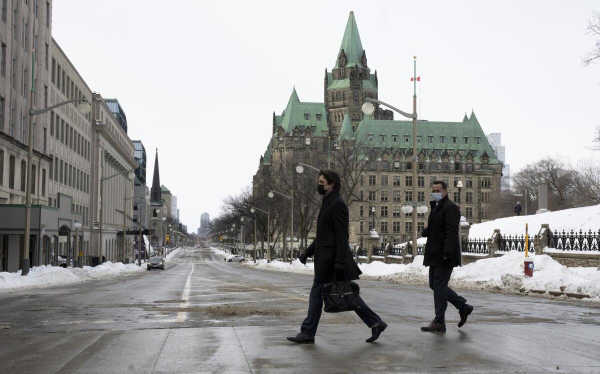 Canadian Prime Minister Justin Trudeau walks across a street in Ottawa.