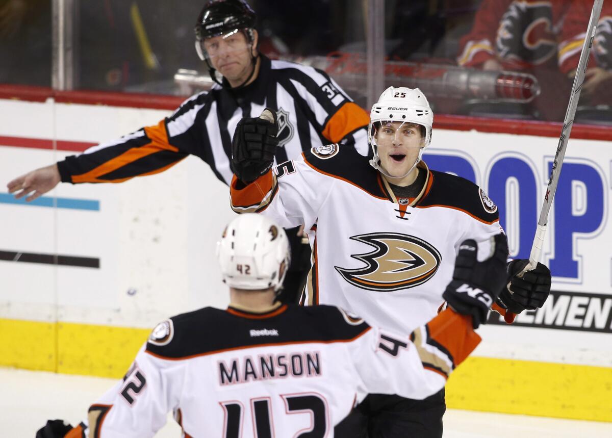 Ducks center Mike Santorelli celebrates with Josh Manson after his goal against the Calgary Flames during the third period.