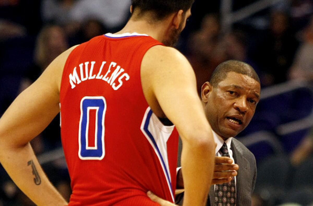 Clippers Coach Doc Rivers talks to reserve big man Byron Mullens during a preseason game Tuesday in Phoenix.