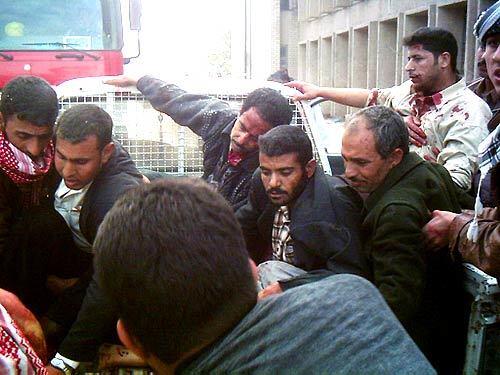 On the morning of February 28, 2005, the car bomb went off in Hillah, killing at least 116 and wounding 133 others. Here, some of the injured are about to be evacuated to the hospital.